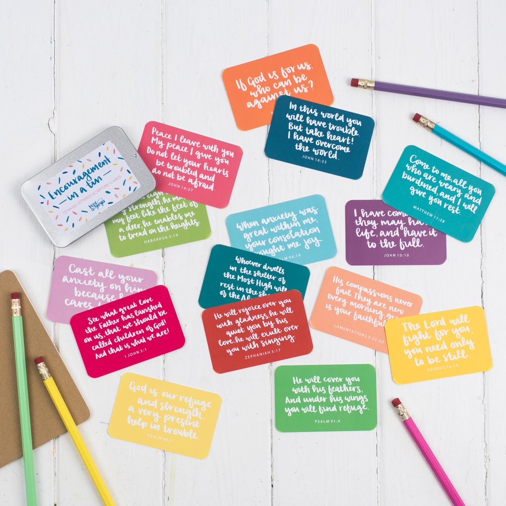 15 brightly coloured hand lettered scripture cards with encouraging scriptures presented in a slide-top tin