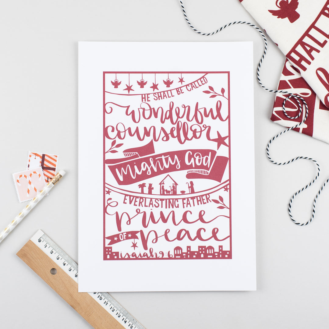 Festive print printed with a hand-drawn paper cut style design in red on white featuring the beautiful words of Isaiah 9:6