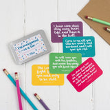 15 brightly coloured hand lettered scripture cards with encouraging scriptures presented in a slide-top tin