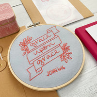 Close up of pink and grey grace upon grace Christian embroidery kit
